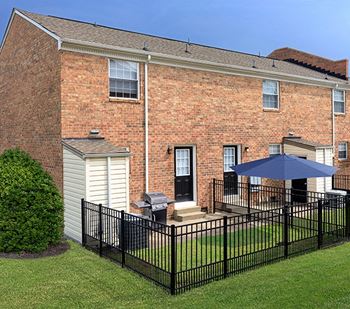 a large brick building with a black fence in front of it